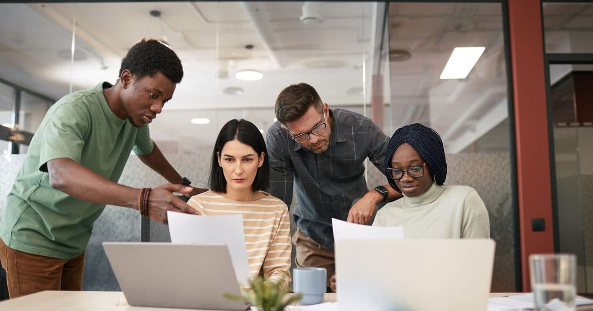 Marketing team reviewing AI-assisted content calendar and ad variations