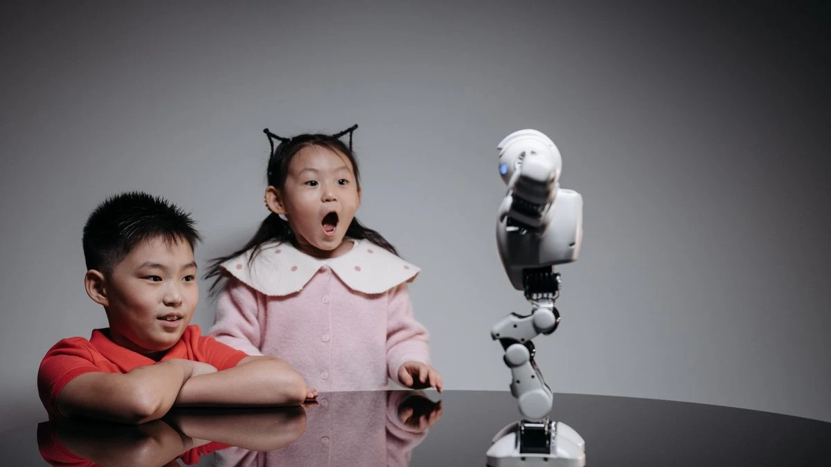 Two children fascinated by a toy robot, showcasing excitement and curiosity indoors.