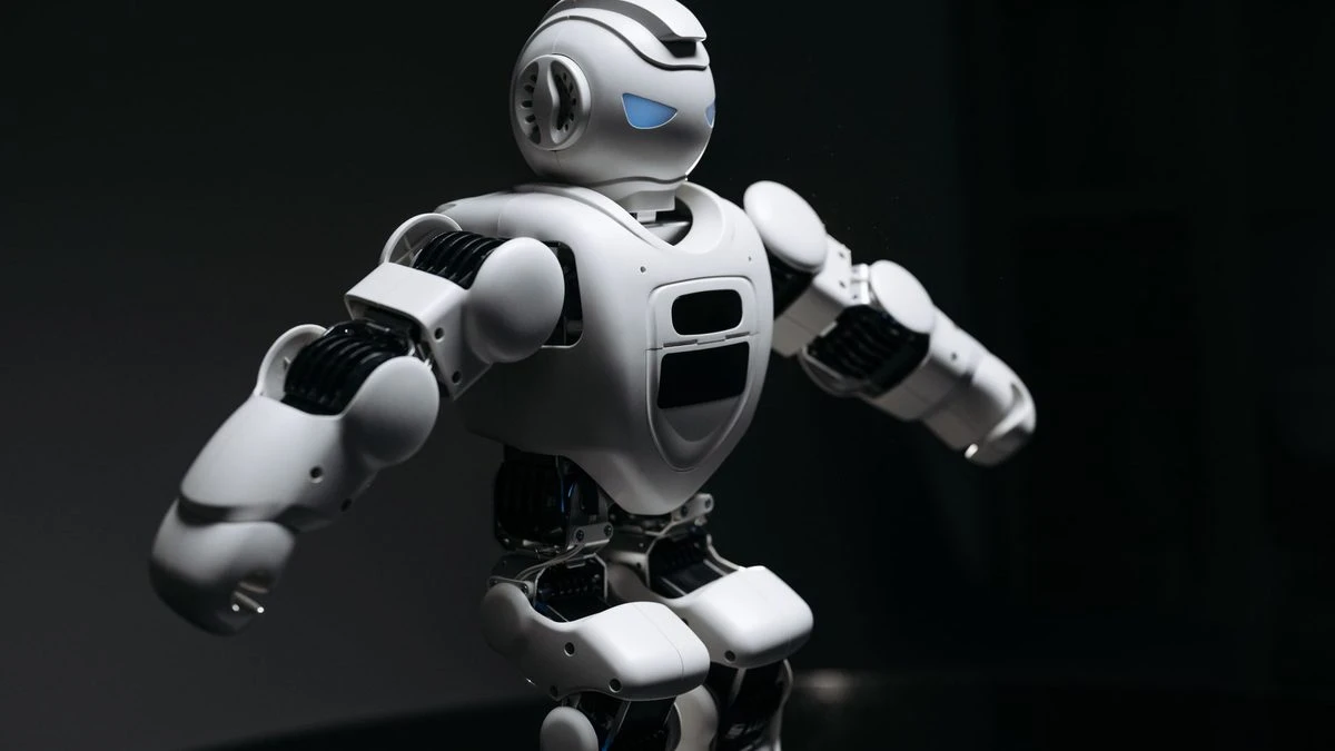 Close-up of a futuristic humanoid robot under dramatic lighting in dark ambiance.