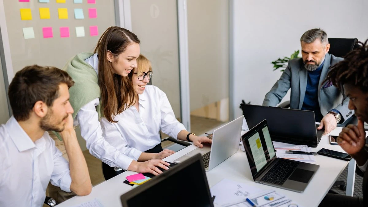 Diverse team of business professionals collaborating in a modern office setting.