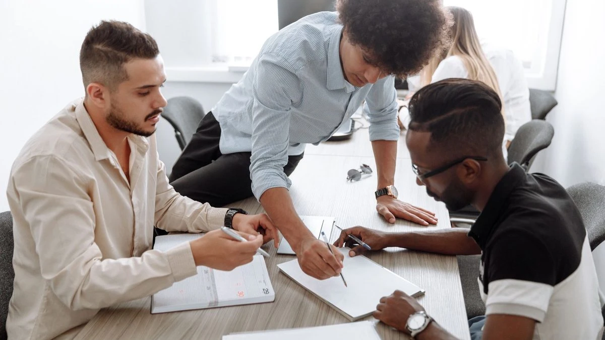 A diverse team of professionals collaborating in a modern office setting, focusing on brainstorming and planning.