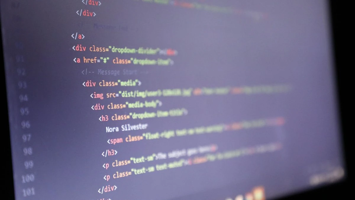 Illuminated HTML code displayed on a computer screen, close-up view.