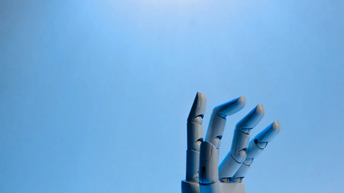Robotic hand with articulated fingers reaching towards the sky on a blue background.