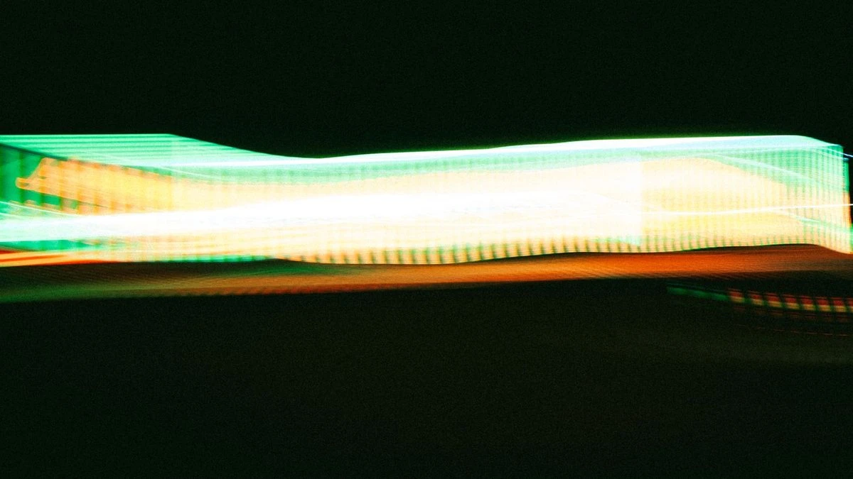 Vibrant abstract pattern of neon light trails creating dynamic energy.