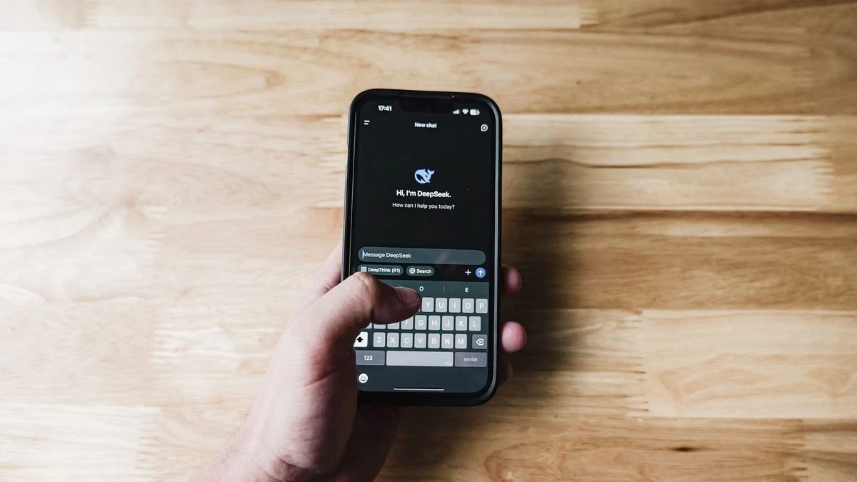 A person interacting with an AI assistant on a smartphone indoors.