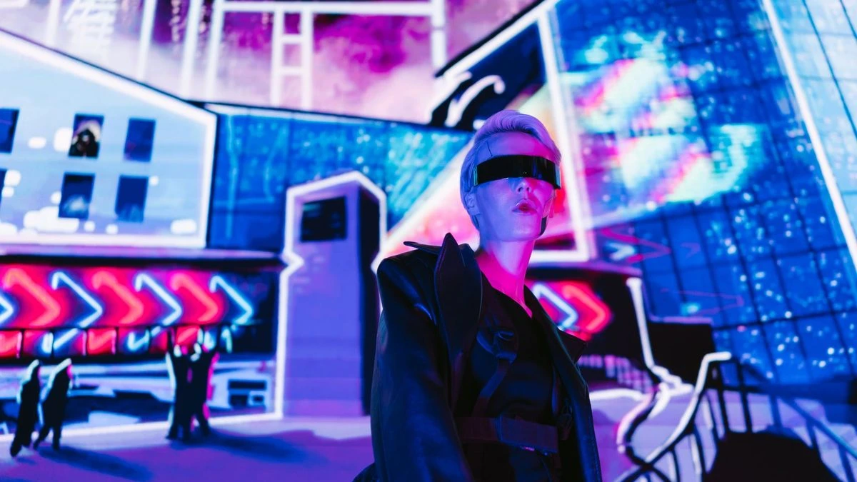 A stylish woman in cyberpunk eyewear under vibrant neon lights.